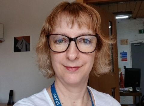Lorna taking a selfie in glasses and lanyard